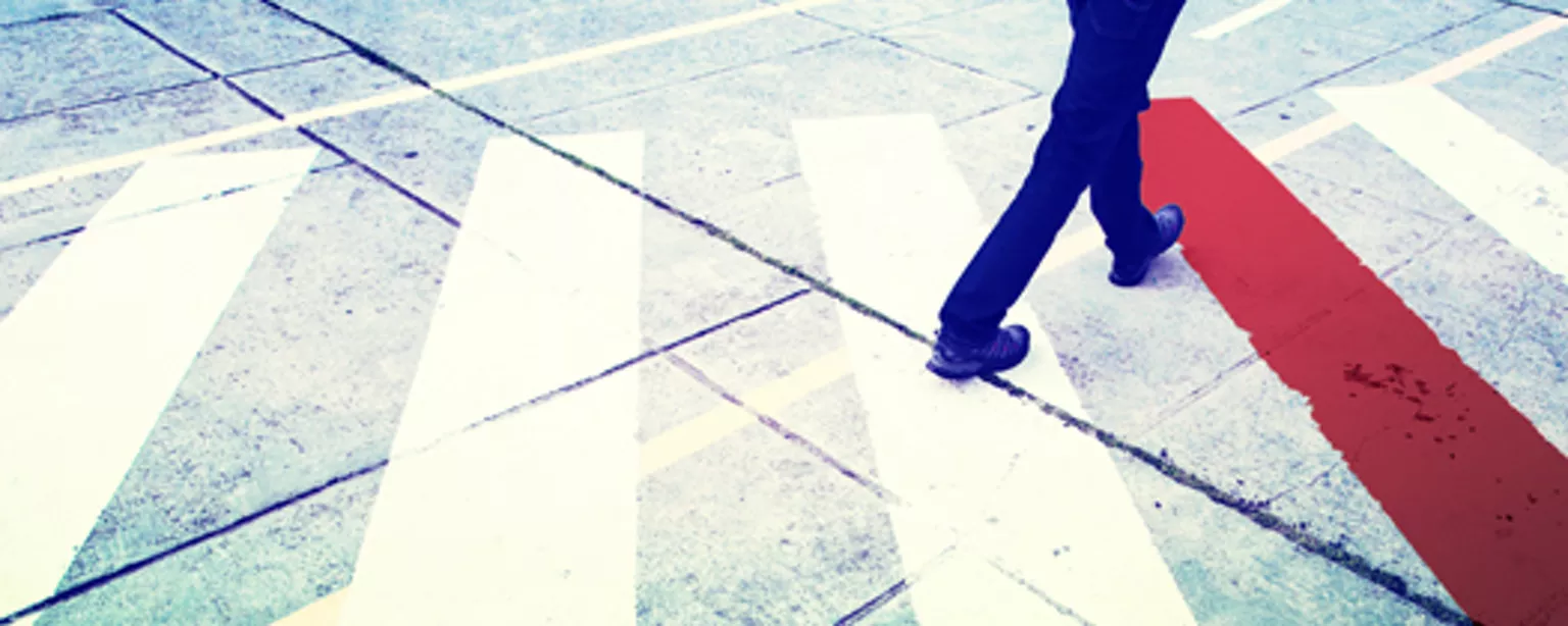 Walking on a crosswalk to a red line signifying professional boundaries