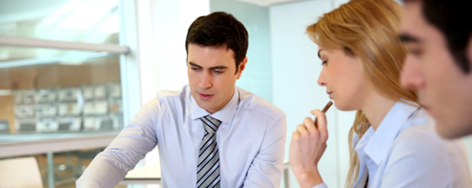 Three accountants at table building confidence at work