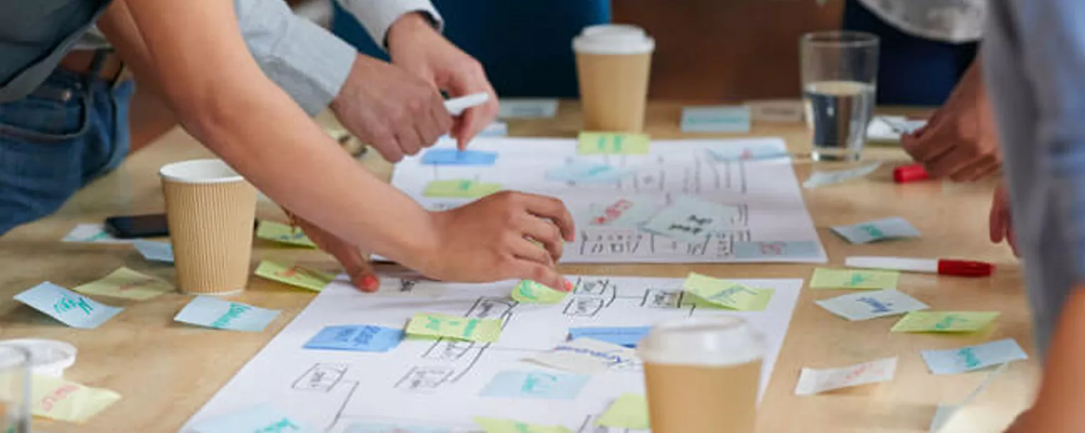 Creative professionals at a table during a brainstorming session.