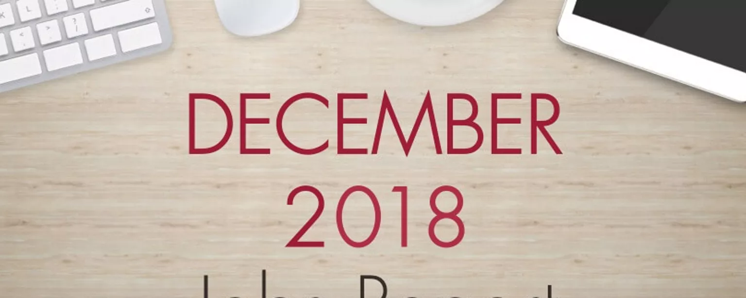 An image of a desk with text that reads, "December 2018 Jobs Report"