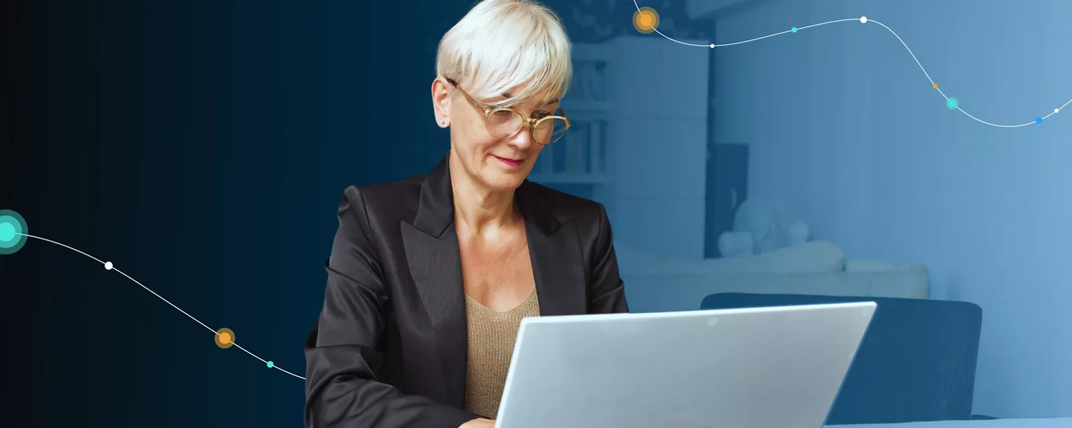 Finance professional reviewing information on a laptop in a contemporary workspace.