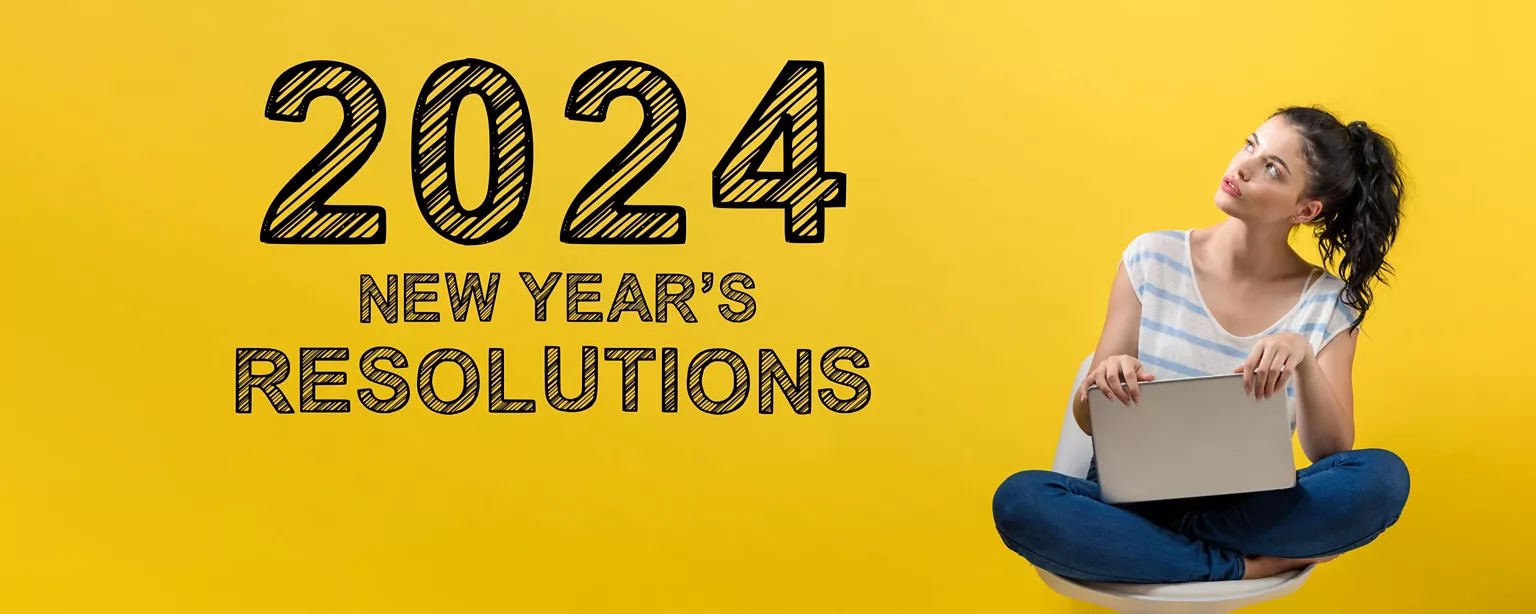 The words “2024 New Year’s Resolutions” appears in black type over a yellow background as a woman with a laptop sits and gazes thoughtfully at the message.