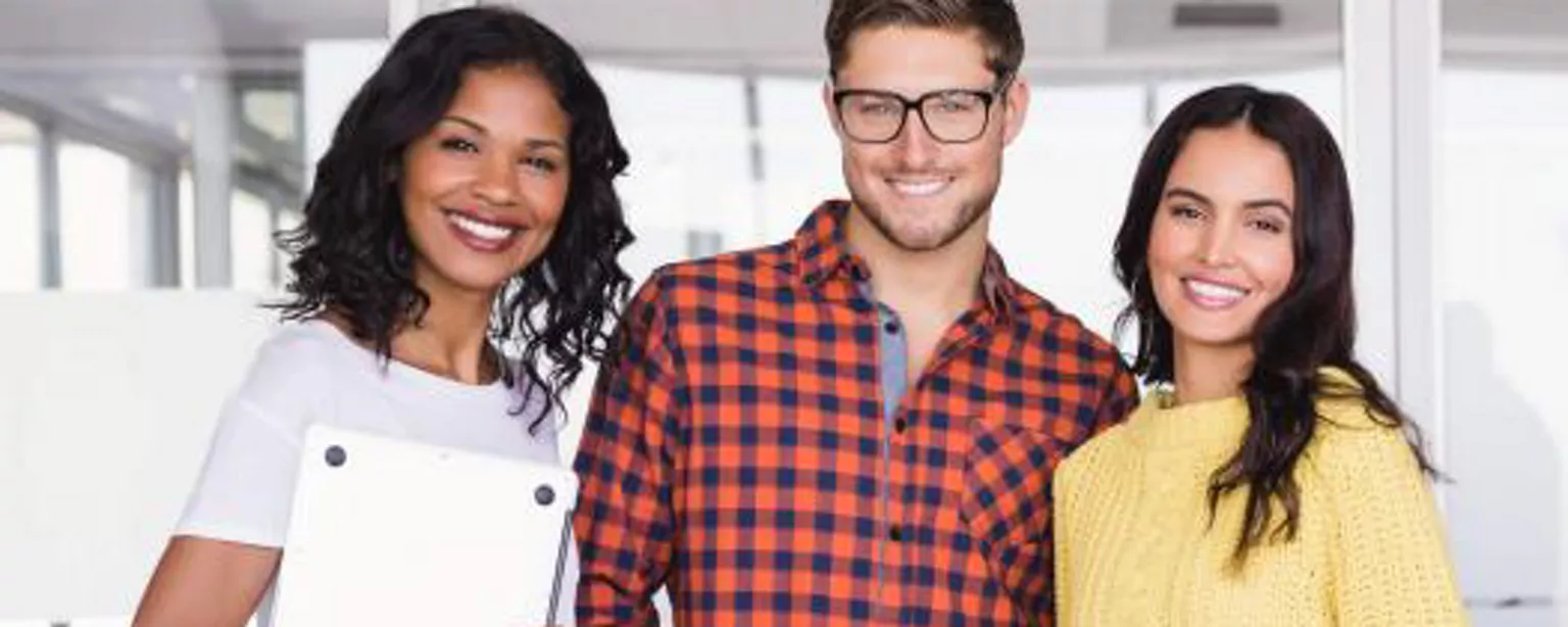 Three employees sporting attire that conforms to a casual dress code