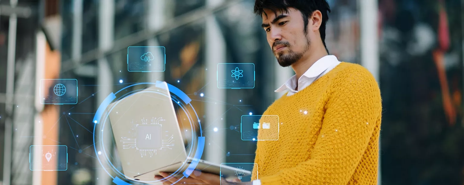 A man in a yellow sweater looks at a laptop, surrounded by floating digital icons representing AI, cloud storage and technology.