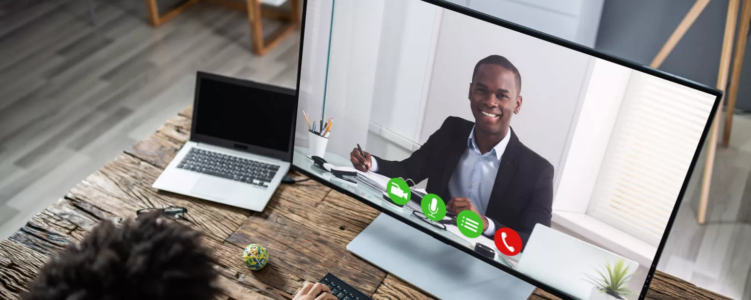 How to Hire Remote Workers, Remotely — person at desk on a video call