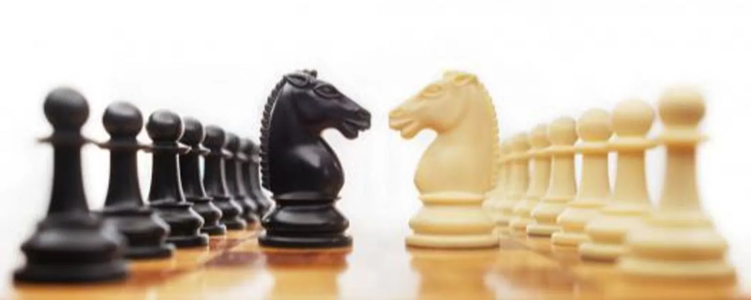 How to Gracefully Resolve Workplace Conflict — depicted with pieces on a chess board