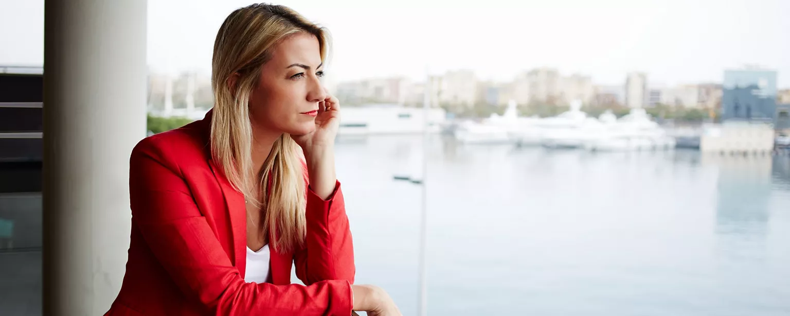 A hiring manager gazes into the distance as she realizes the company’s hiring practices will need to be adjusted to attract better job candidates.