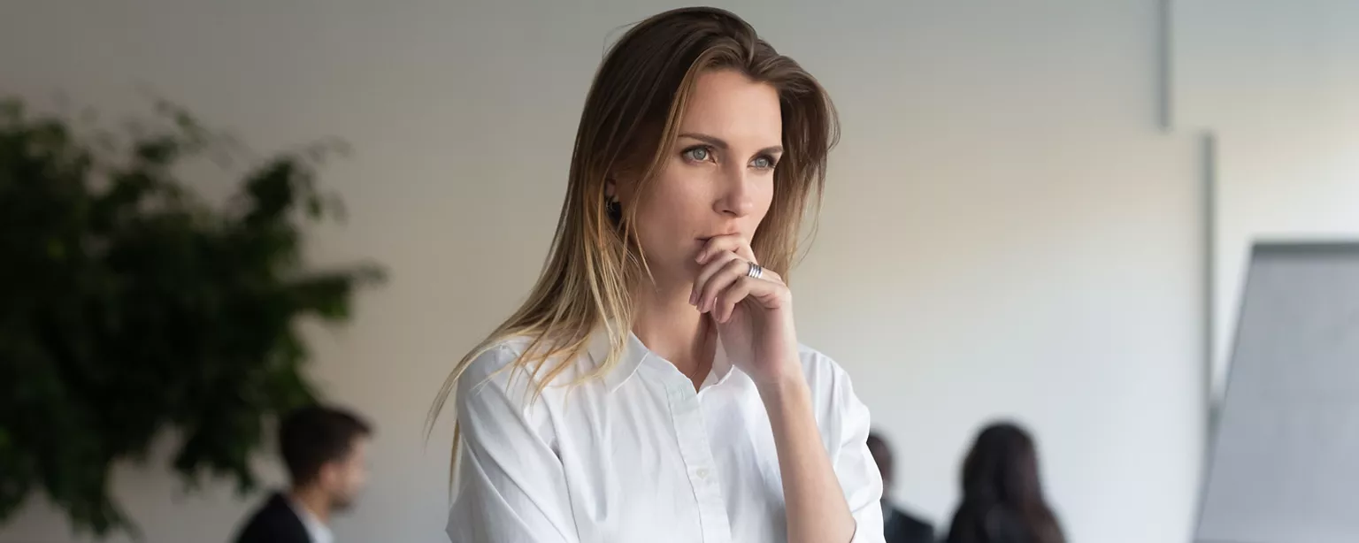 A woman gives thought to how to answer the question, "What's your expected salary."