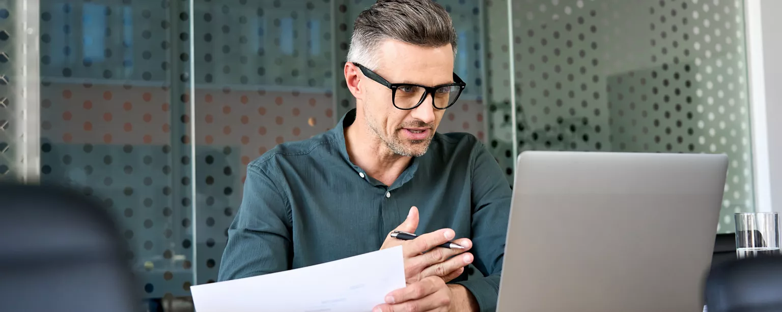 A man speaking to his laptop screen and negotiating salary