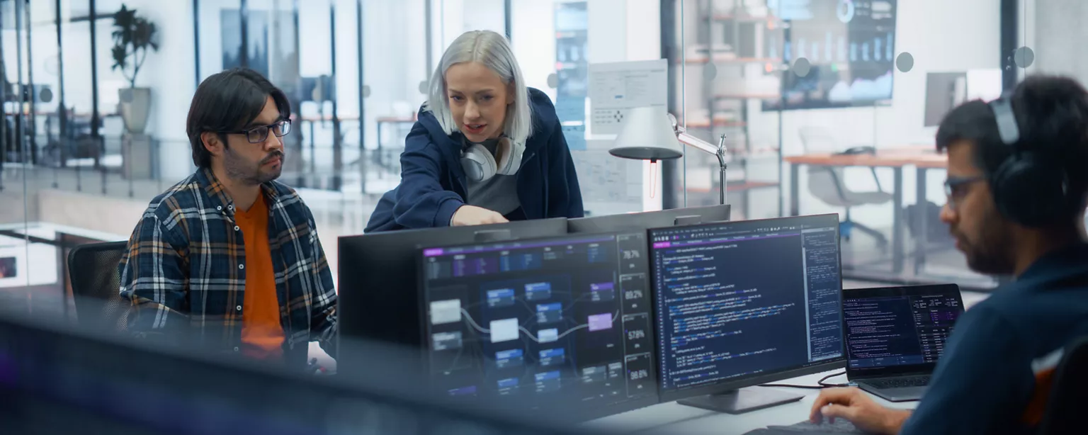 tech employees working at computers in an office