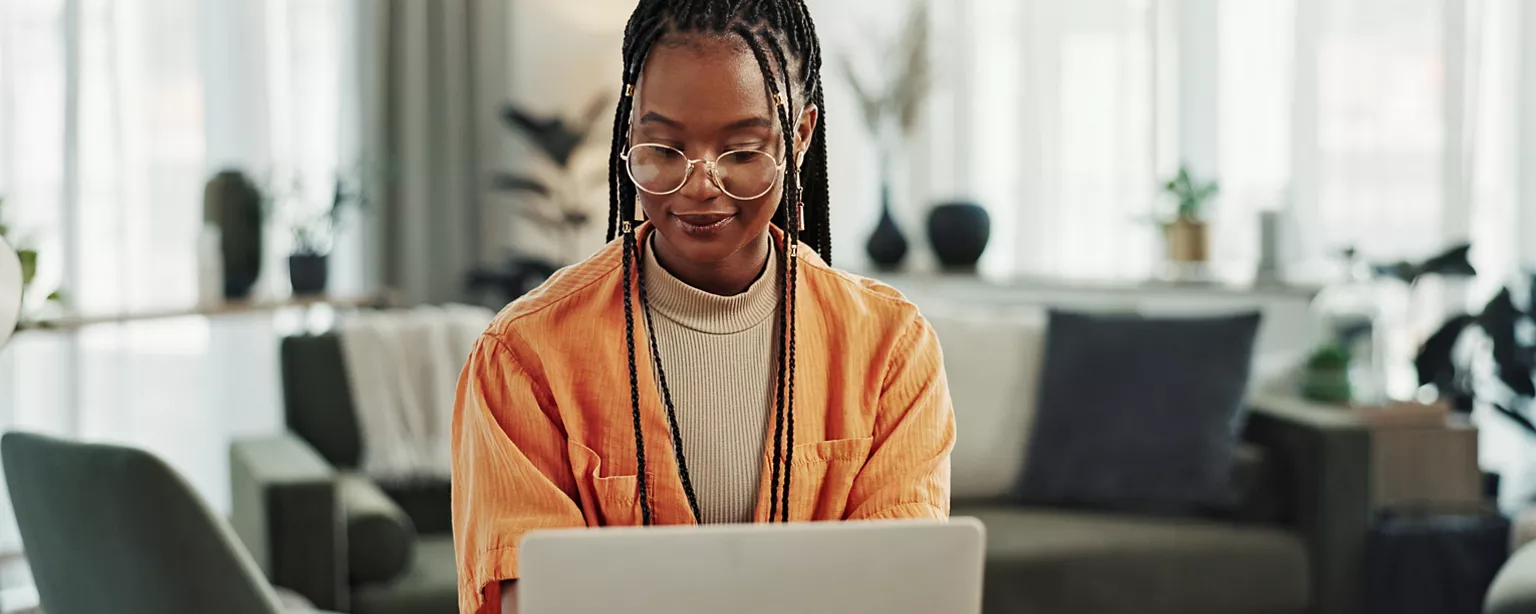 a woman working on her laptop reviewing the statistics canada labour force survey
