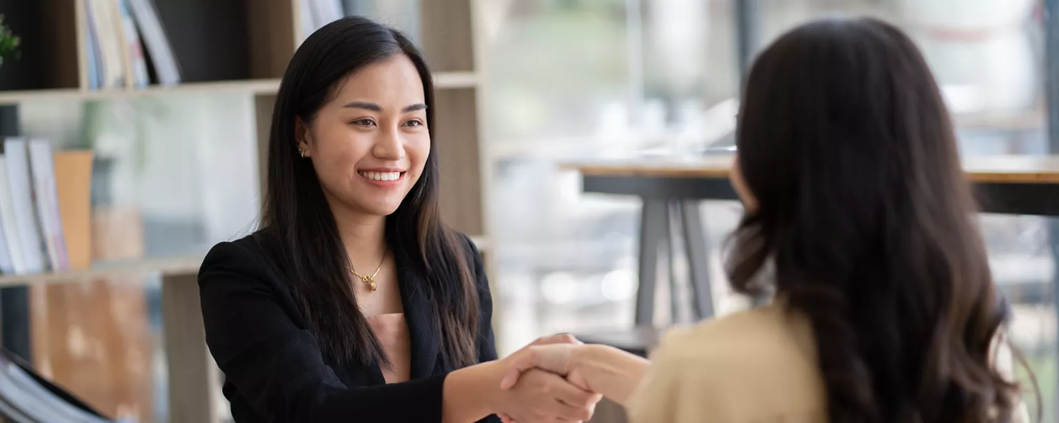 two businesswomen shaking hands
