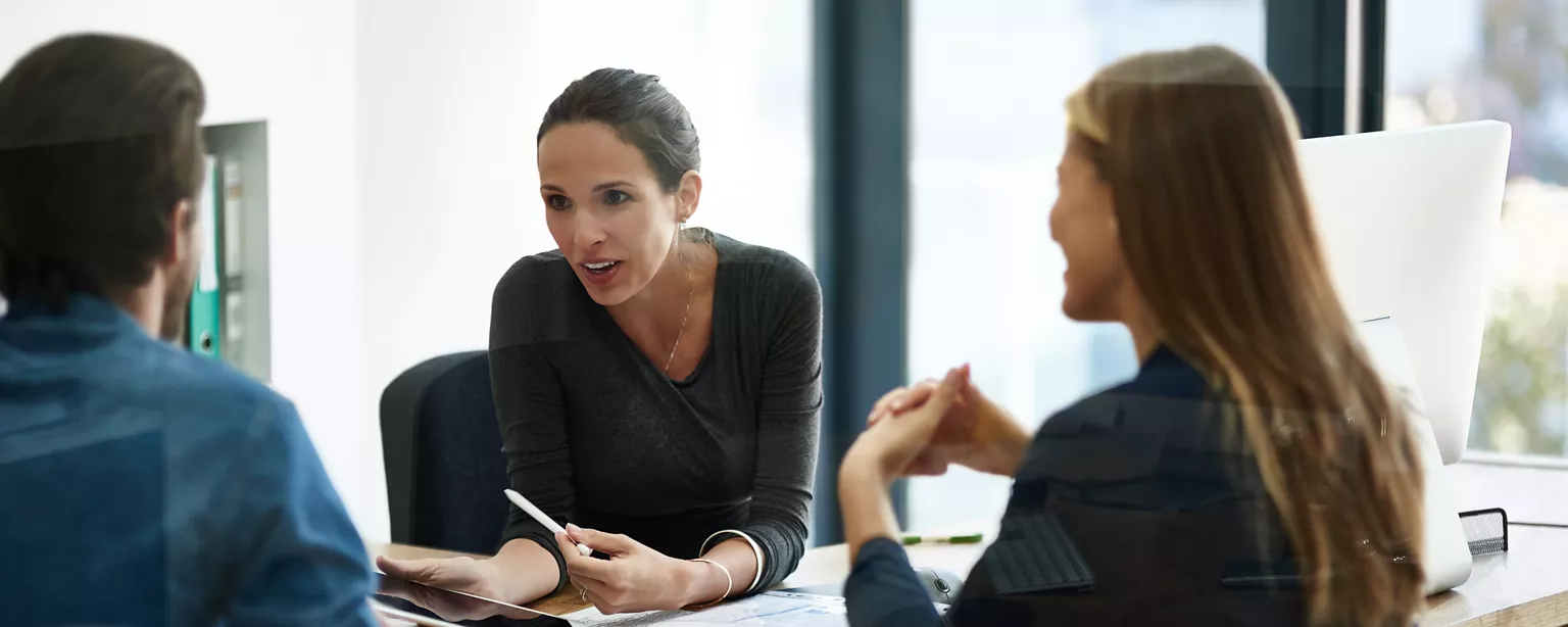 An office conversation between three individuals