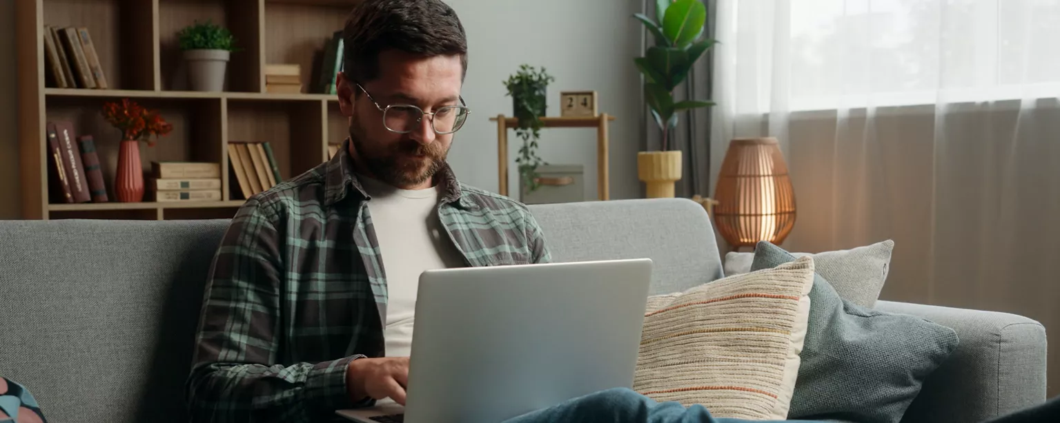 man working from home on his laptop