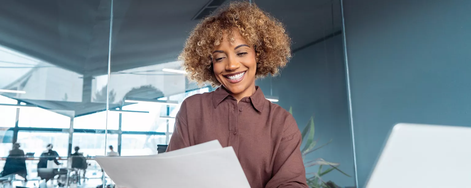 Woman looking happily at her cover letter