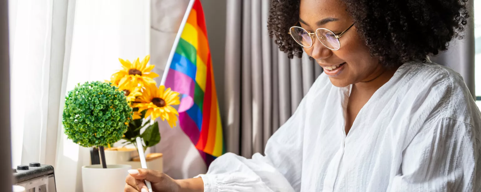 "Celebrating Pride Month" against a rainbow-striped background with Robert Half logo and EOE and copyright line.