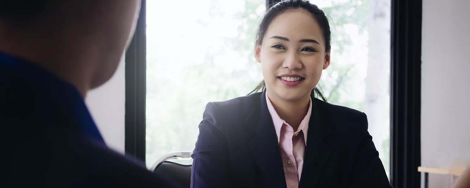 A lawyer seeking a job answers questions during an interview.