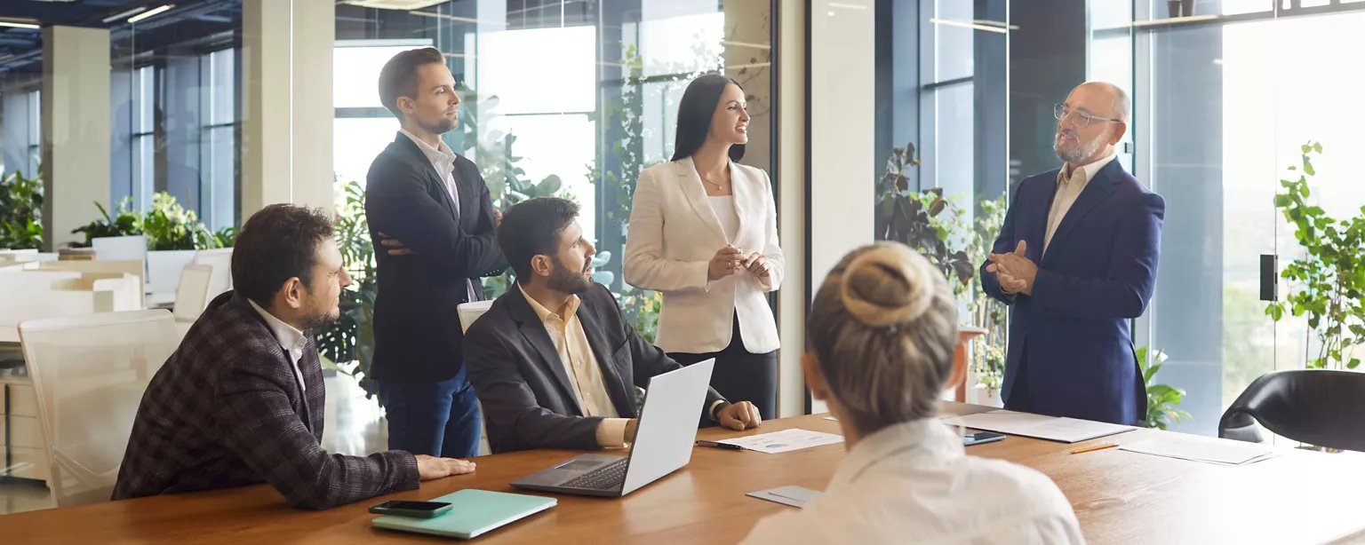 A manager leads a team discussion in a conference room.
