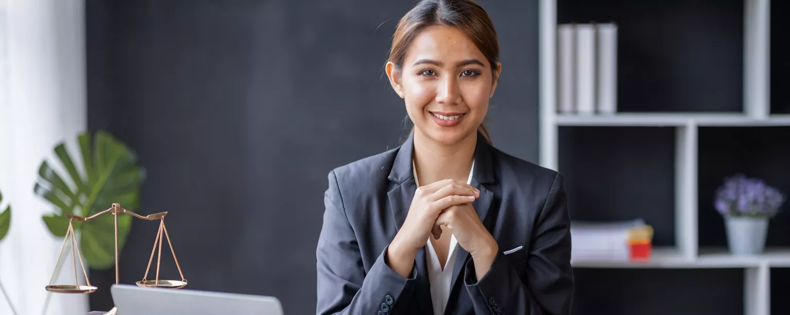 A corporate lawyer sits at her desk, awaiting what the day will bring.