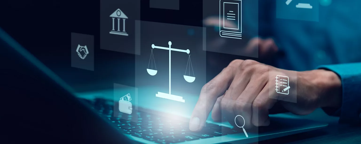 A person uses a laptop surrounded by digital legal icons.