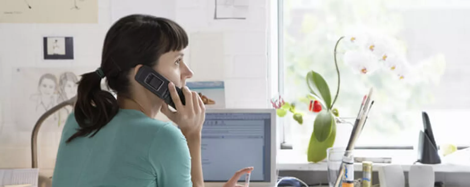 Image of a telecommuter in her home office.