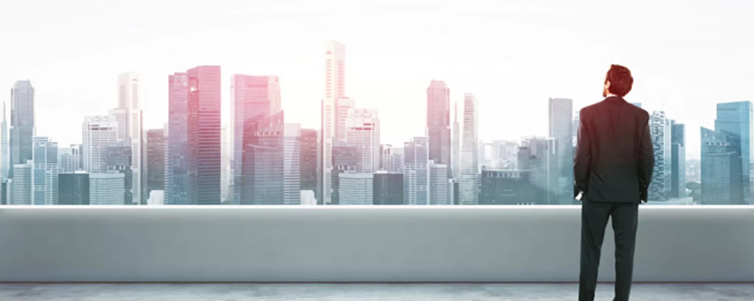 Man in suit looking at big city