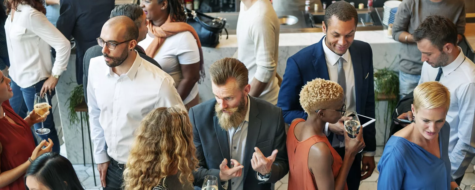 Several people mingle and get to know each other at a business networking event.