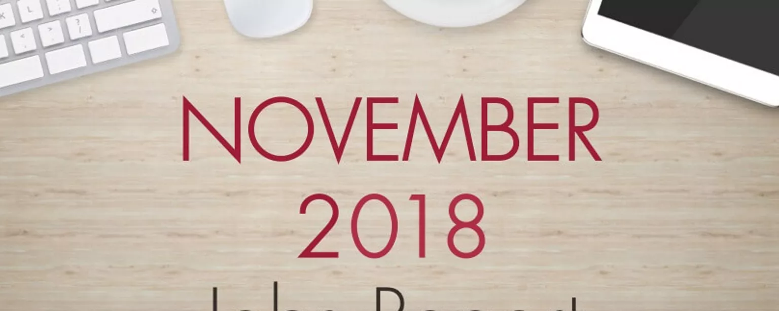 An image of a desk with text that reads, "November 2018 Jobs Report"