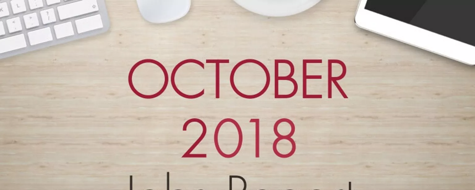 An image of a desk with text that reads, "October 2018 Jobs Report"