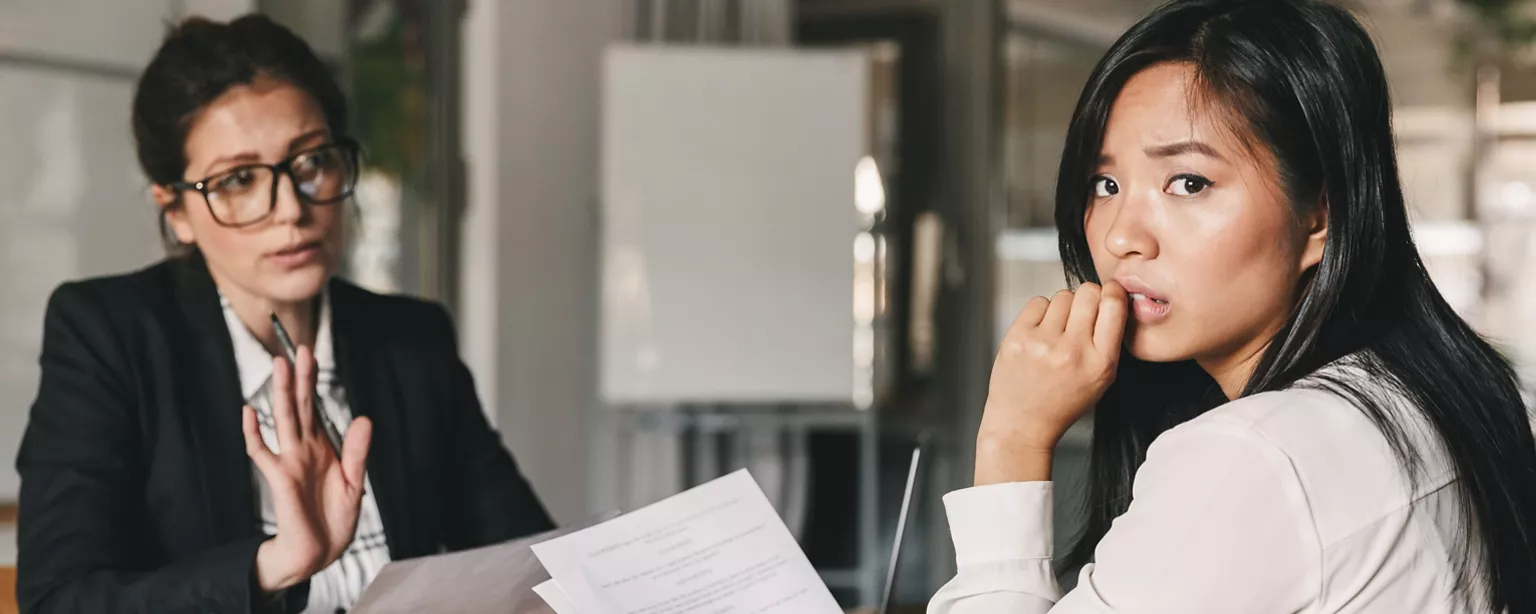 A job candidate looks nervous during an interview as she wonders if she said the wrong thing.