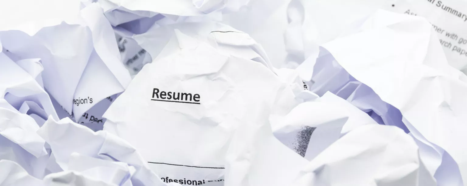 Image of crumpled resume in trash.