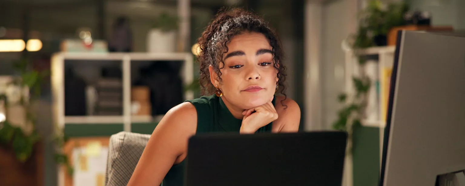 Young businesswoman looking at her laptop in a modern office