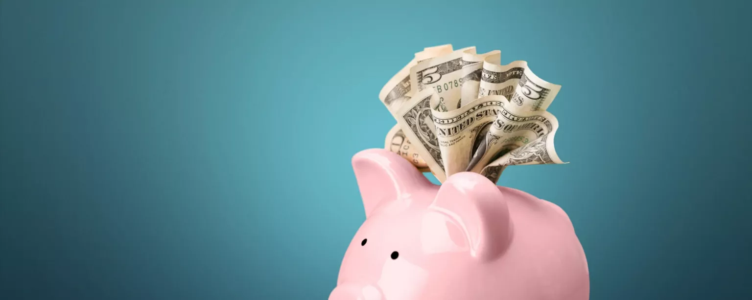 Image of an overflowing piggy bank representing today's top-paying jobs.
