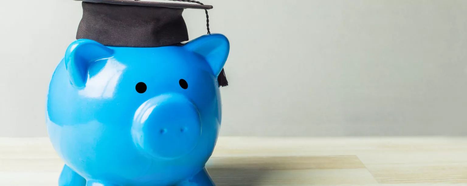 Piggy bank with mortarboard representing salary for recent college graduates