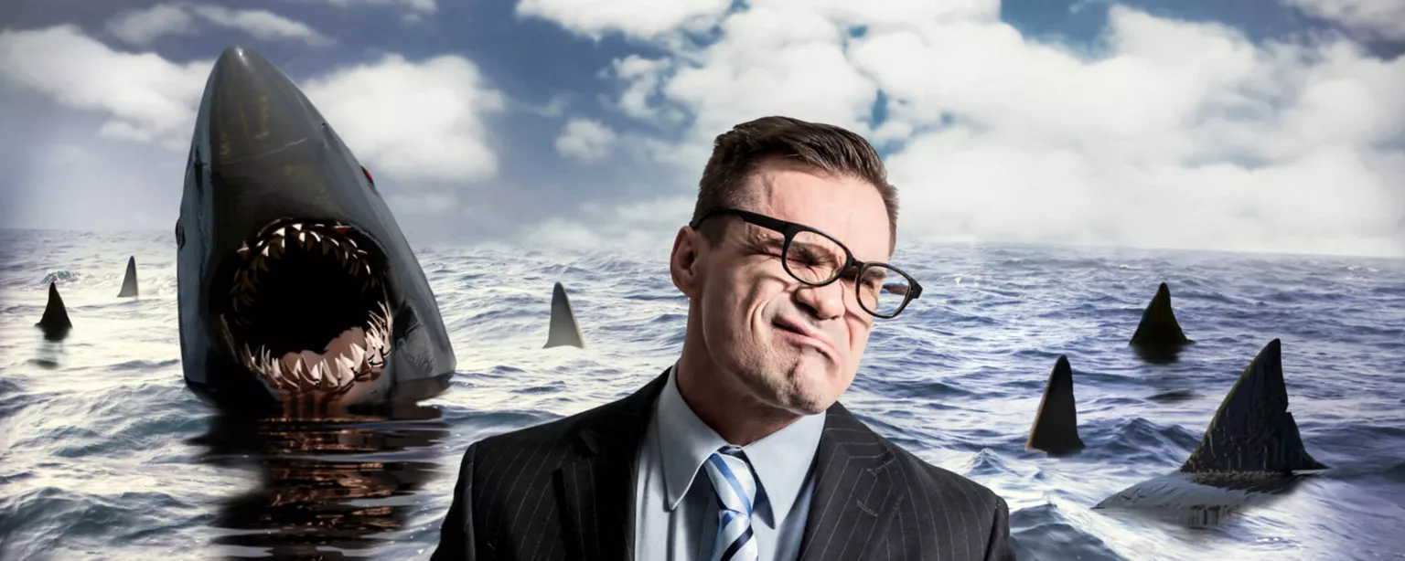 Illustration of an employee in the ocean surrounded by sharks.