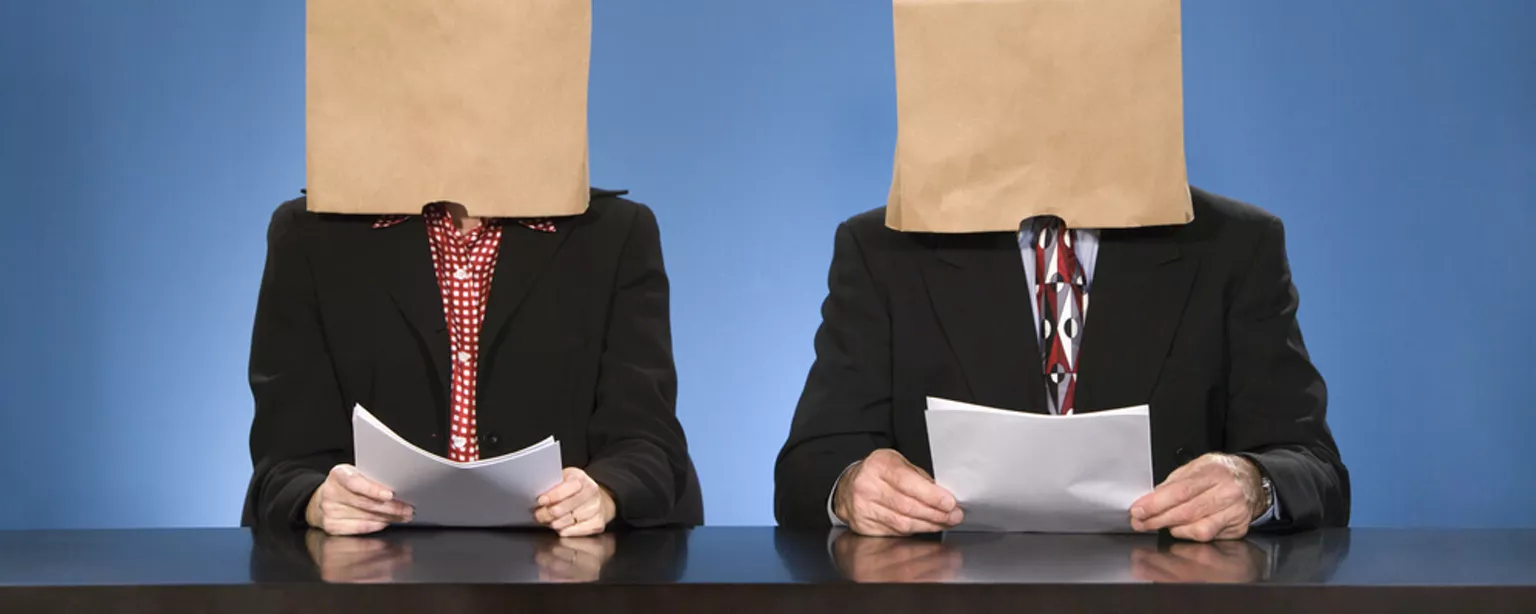 Man and woman with their faces covered to remove any recruitment bias