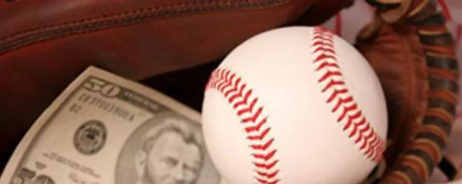 Cash and a baseball representing sports accounting jobs