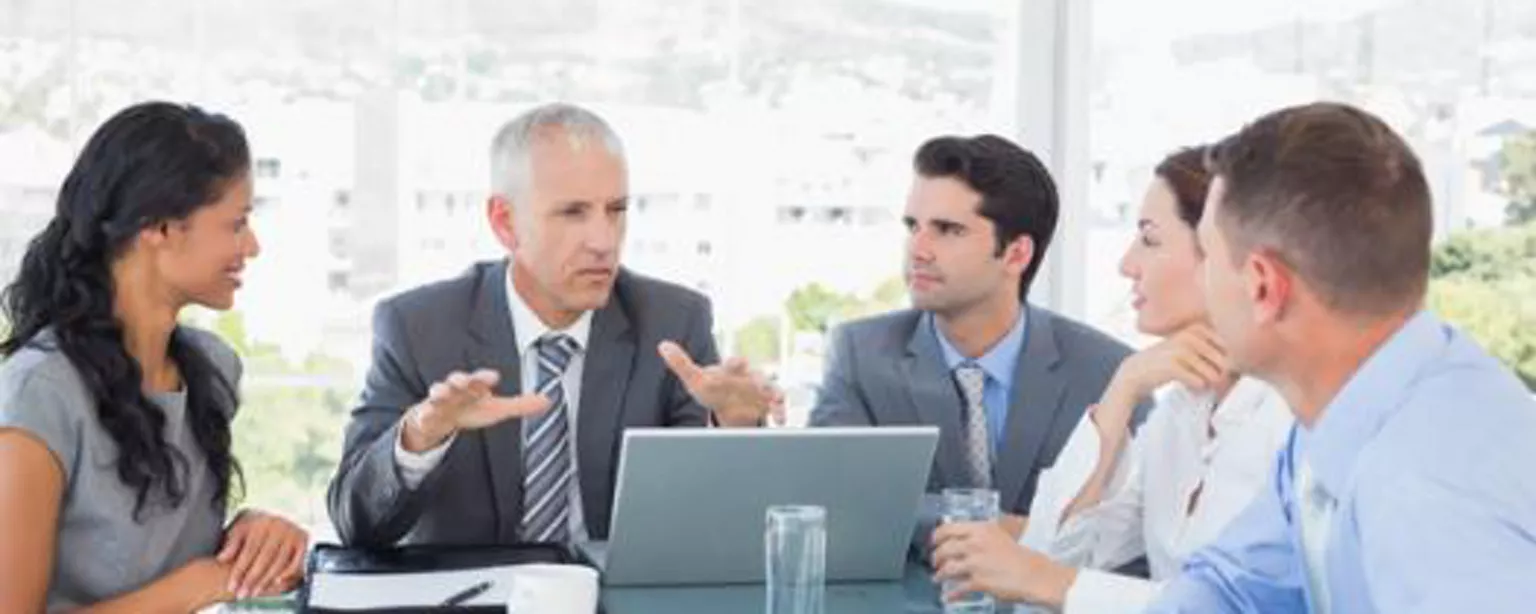 Manager holds a staff meeting with his multigenerational team