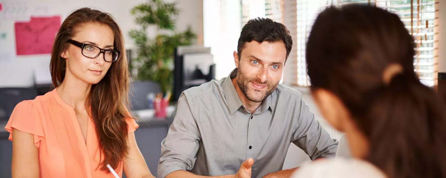 Two hiring managers ask a candidate why they are making the move during a job interview