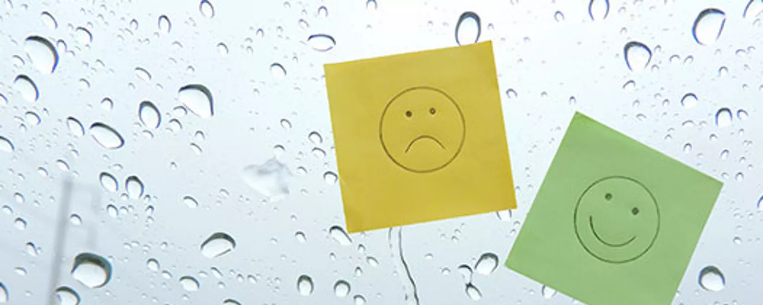 Image of a sad face and a happy face on post-it notes signifying a change in feelings about work