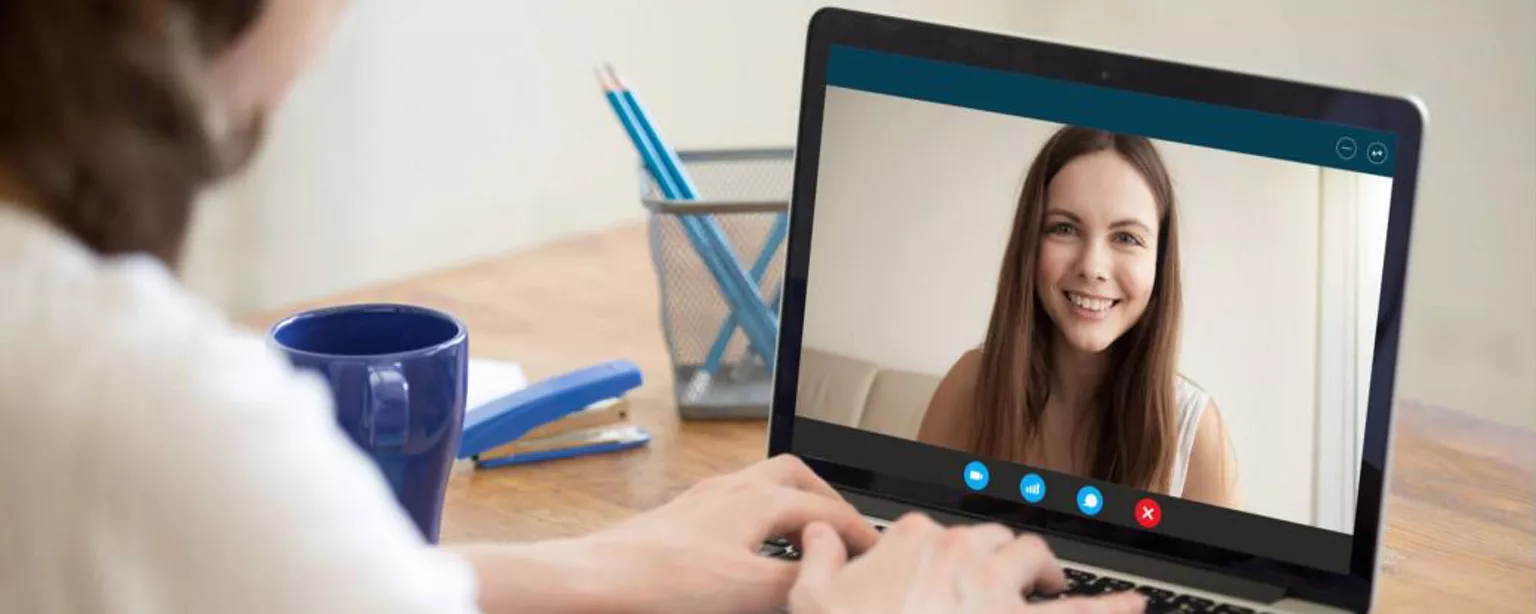 Image of a woman on a laptop during a video job interview.