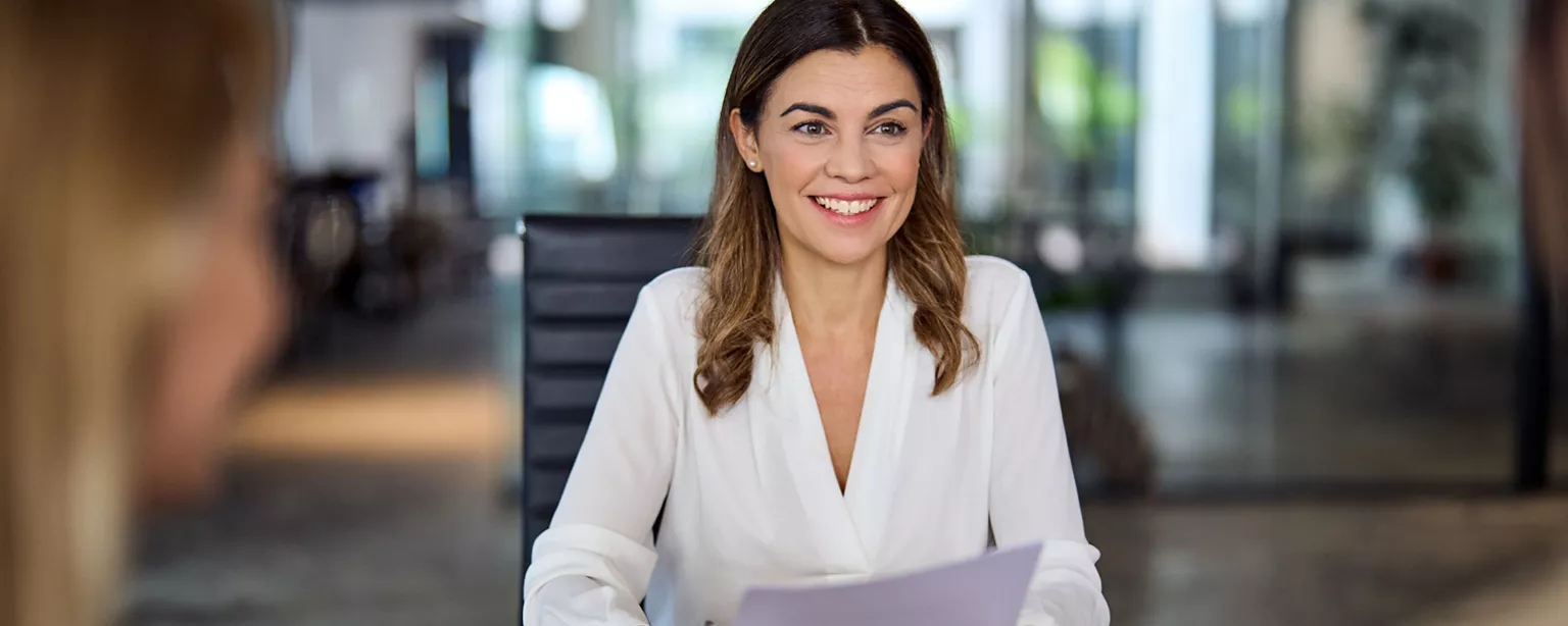 A candidate for a paralegal job smiles during a job interview she got on the strength of her paralegal resume. 