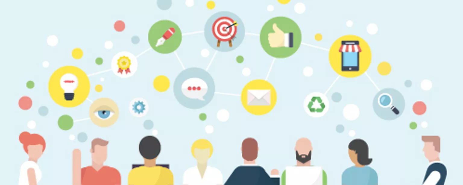 A group of people working at an agency discuss creative ideas around a conference table