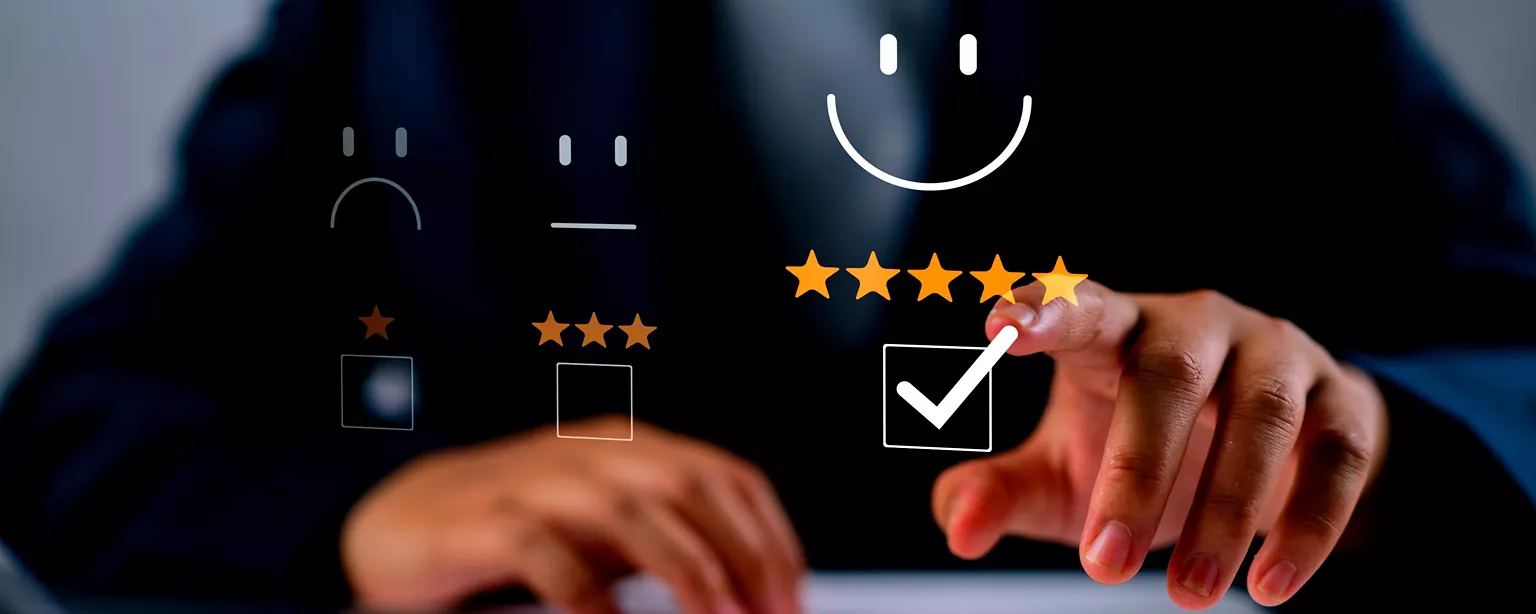 Person pointing to a check mark and five stars with a smiley face