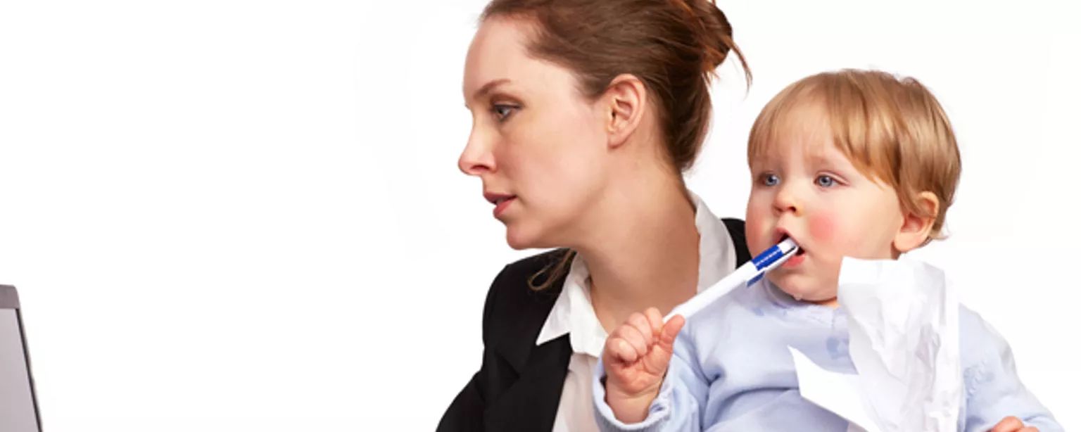 Woman with toddler on lap showing the life of working mom 