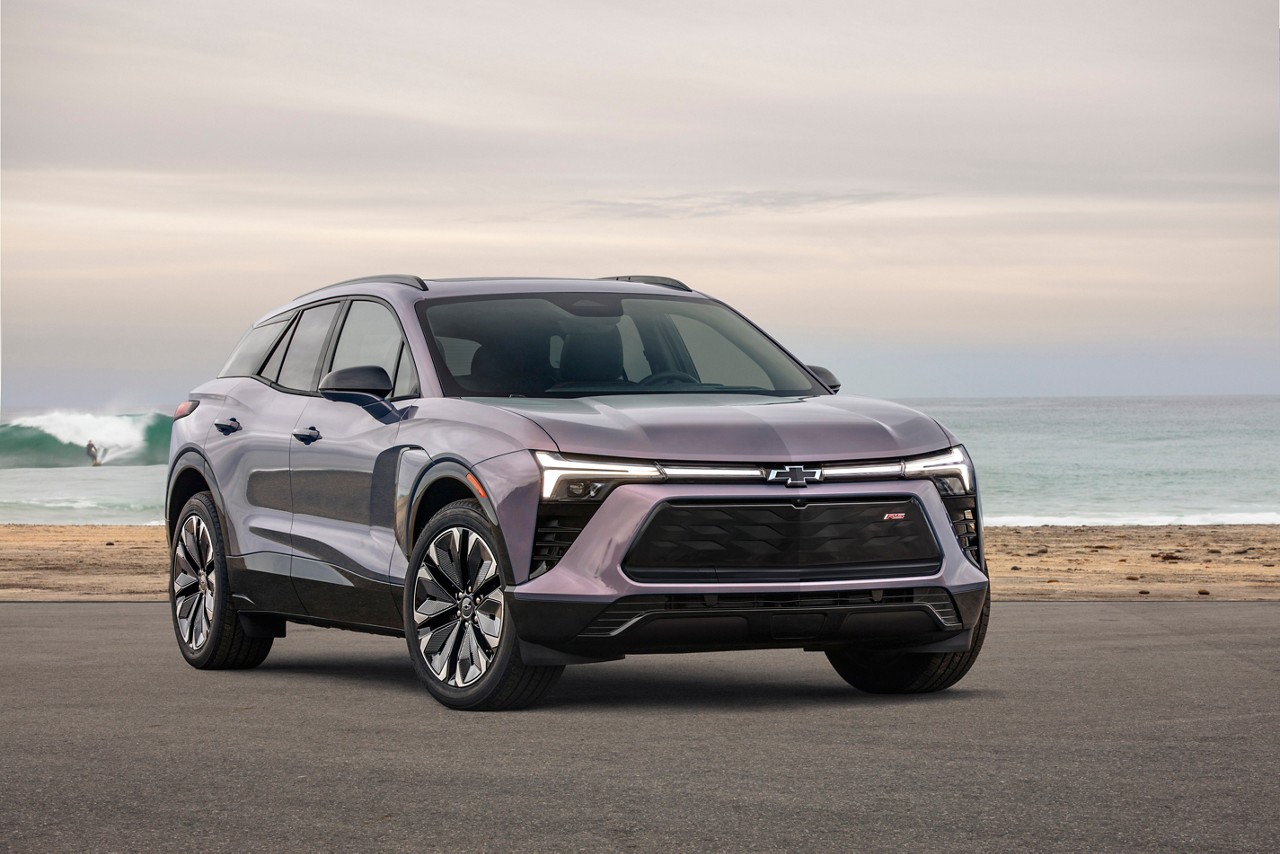 Front 3/4 view of the 2024 Chevrolet Blazer EV in Galaxy Gray Metallic parked in front of a beach.