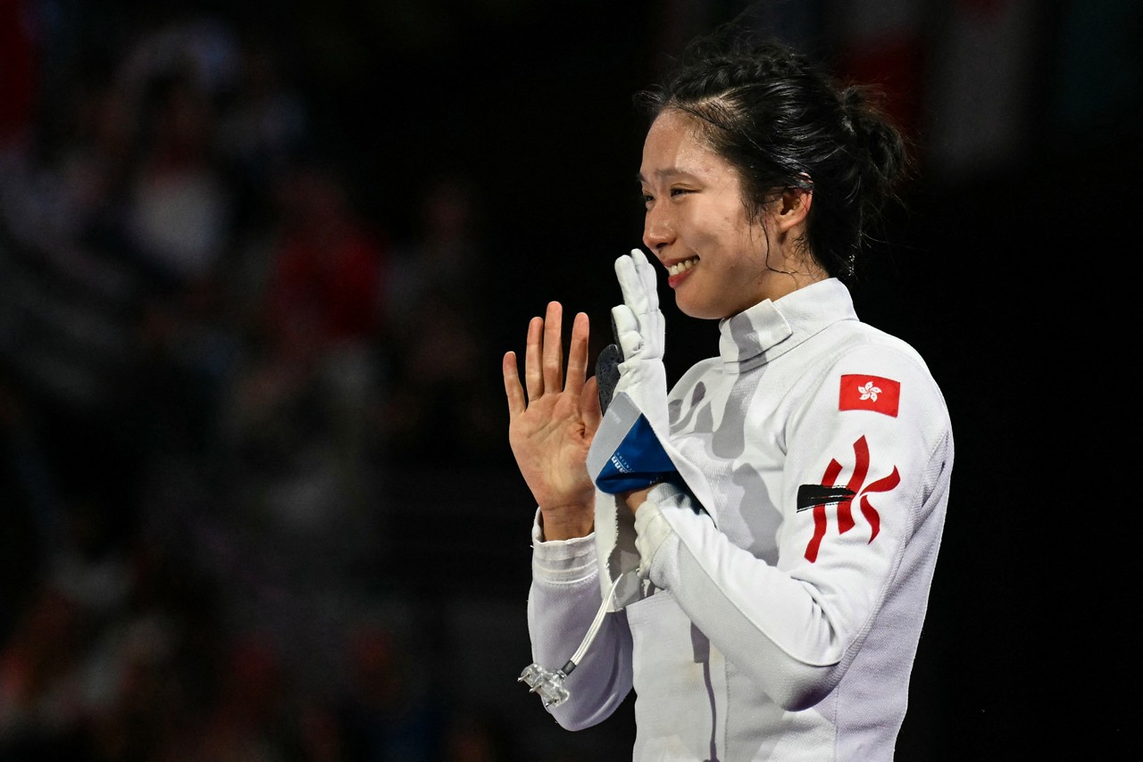 Hong Kong's Kong Man Wai Vivian celebrates after winning against France's Auriane Mallo-Breton in the women's epee individual gold medal bout during the Paris 2024 Olympic Games at the Grand Palais in Paris, on July 27, 2024. (Photo by Fabrice COFFRINI / AFP)
