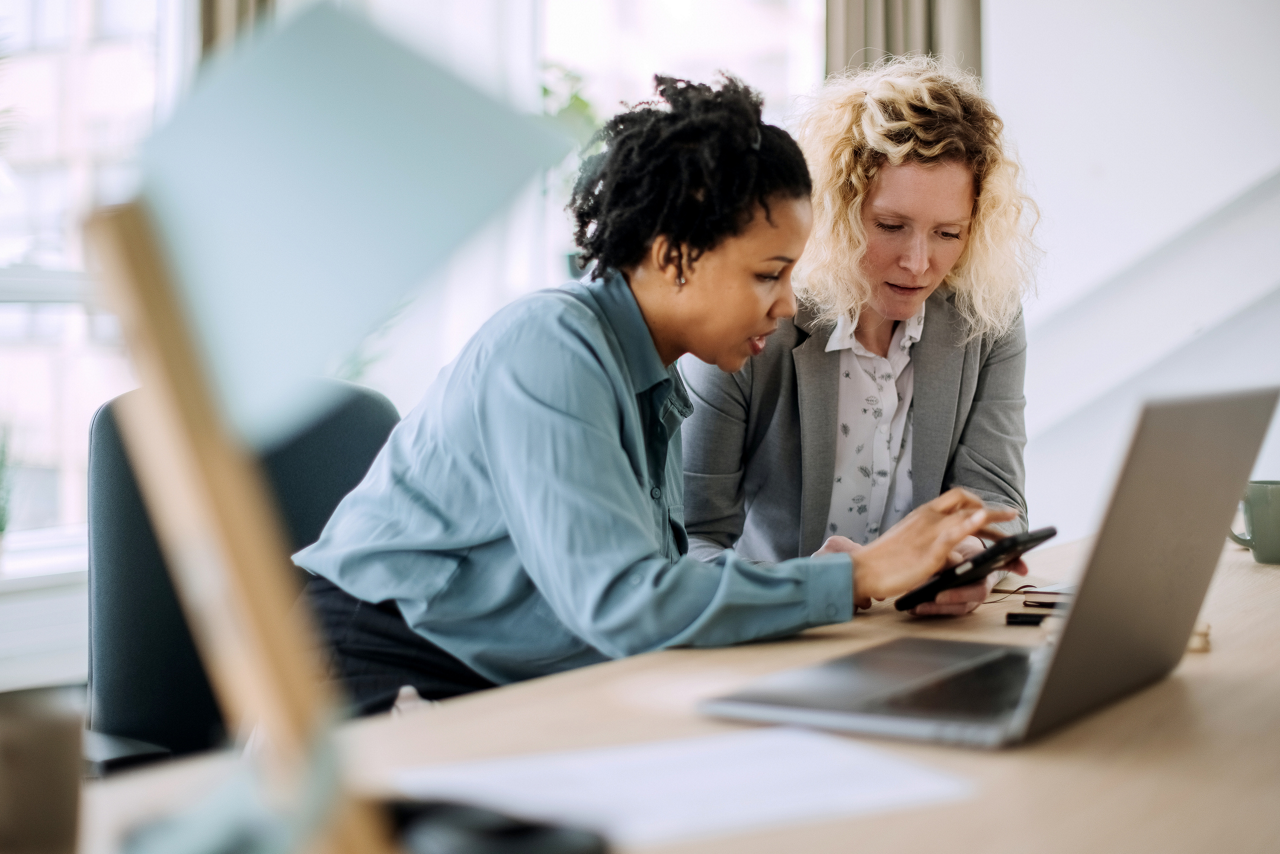 Two ladies looking at mobile device