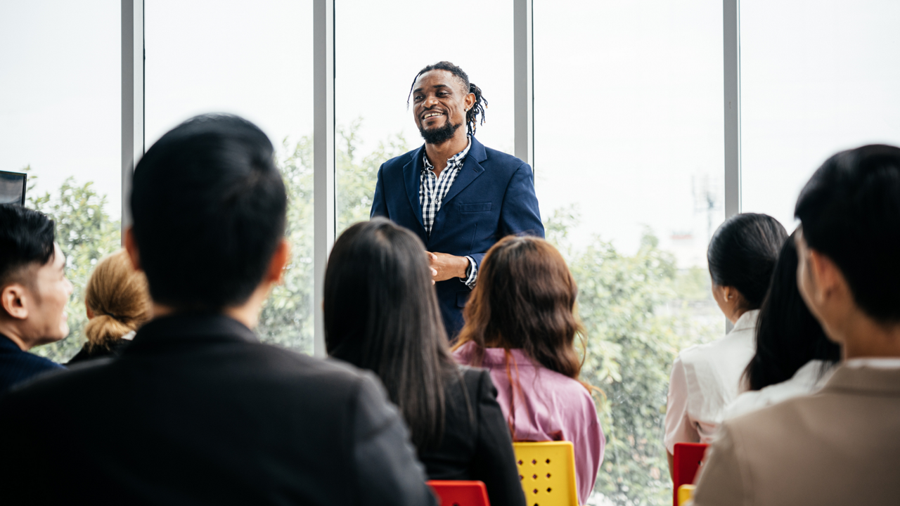 African American coworkers in meeting talking about annual profit in a boardroom