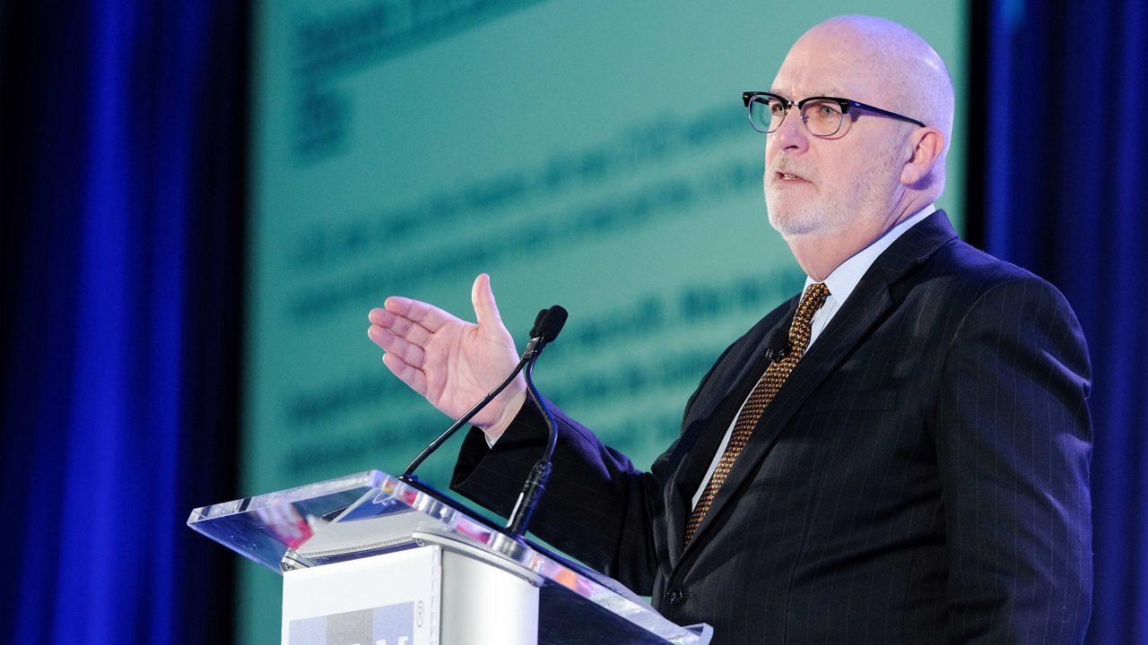 A man in a suit and tie giving a speech.